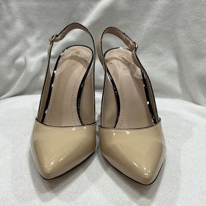 Nude slingbacks with black heel and trim.